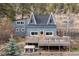 Charming mountain home featuring a spacious deck, unique architecture, and nestled amongst beautiful trees at 1264 Beaver Brook Canyon Rd, Evergreen, CO 80439