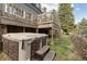Backyard oasis features a covered hot tub, wooden steps and a grassy lawn at 1264 Beaver Brook Canyon Rd, Evergreen, CO 80439