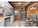 Modern kitchen with stainless steel appliances, light countertops, white cabinets, and wood accents at 1264 Beaver Brook Canyon Rd, Evergreen, CO 80439