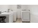 Functional laundry room with modern washer and dryer set and sink at 1264 Beaver Brook Canyon Rd, Evergreen, CO 80439