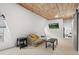 Inviting living room with vaulted wood ceiling and picturesque mountain view TV at 1264 Beaver Brook Canyon Rd, Evergreen, CO 80439