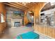 Beautiful living room with stone fireplace and views to modern kitchen at 1264 Beaver Brook Canyon Rd, Evergreen, CO 80439