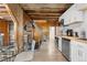 Living and kitchen area with wood-paneled walls and ceilings, staircase to living area, and access to kitchen at 1264 Beaver Brook Canyon Rd, Evergreen, CO 80439