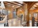 Cozy kitchen and dining area with wood-paneled walls and ceilings, and staircase to another living area at 1264 Beaver Brook Canyon Rd, Evergreen, CO 80439