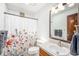 Bathroom featuring a shower curtain, single sink vanity and tiled floors at 1152 Clubhouse Dr, Broomfield, CO 80020