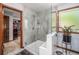Contemporary bathroom with a glass-enclosed shower, a walk-in closet and a grey-tiled shower at 1152 Clubhouse Dr, Broomfield, CO 80020