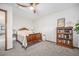 Comfortable bedroom with a ceiling fan, bookshelf and a classic wood bed frame at 1152 Clubhouse Dr, Broomfield, CO 80020