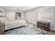Cozy bedroom with a patterned bedspread, storage chest, and a bright window at 1152 Clubhouse Dr, Broomfield, CO 80020