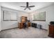 Cozy bedroom with a ceiling fan, carpet floors, two windows and an office workspace at 1152 Clubhouse Dr, Broomfield, CO 80020