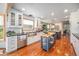Spacious kitchen with white cabinets, a farmhouse sink, stainless steel appliances, and a wooden island at 1152 Clubhouse Dr, Broomfield, CO 80020