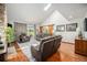 Bright living room with vaulted ceilings, skylight, hardwood floors and access to a golf course view at 1152 Clubhouse Dr, Broomfield, CO 80020
