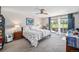 Bright main bedroom with a ceiling fan, an ensuite bath, and a sliding glass door to outdoor patio at 1152 Clubhouse Dr, Broomfield, CO 80020