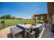 Outdoor patio area overlooking a green golf course with a pergola and cushioned seating at 1152 Clubhouse Dr, Broomfield, CO 80020