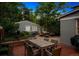 Charming backyard with brick patio, outdoor dining furniture, and detached garage at 428 N Humboldt St, Denver, CO 80218