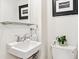Cozy powder room featuring a sleek sink, modern fixtures, and stylish decor at 428 N Humboldt St, Denver, CO 80218