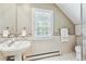 Neutral bath with large window, sleek sink, and mosaic tile at 428 N Humboldt St, Denver, CO 80218