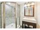 Bathroom featuring a sleek shower with mosaic tile and modern vanity with updated lighting at 428 N Humboldt St, Denver, CO 80218