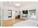 This bedroom boasts a stylish chandelier, an ensuite bathroom and a large TV at 428 N Humboldt St, Denver, CO 80218