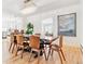 Bright dining room features hardwood floors, contemporary chandelier, and a unique wood table with seating for eight at 428 N Humboldt St, Denver, CO 80218