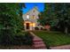 Charming two-story home with a brick walkway, lush landscaping, and inviting front porch seating at 428 N Humboldt St, Denver, CO 80218