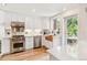 Bright kitchen with white cabinets, tile backsplash, stainless appliances, and a copper farmhouse sink at 428 N Humboldt St, Denver, CO 80218