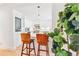 Bright kitchen with white cabinets, tile backsplash, stainless appliances, and breakfast bar seating at 428 N Humboldt St, Denver, CO 80218
