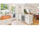 Bright kitchen with breakfast bar, white cabinets, tile backsplash, copper farmhouse sink, and a wine fridge at 428 N Humboldt St, Denver, CO 80218