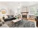 Stylish living room featuring hardwood floors, fireplace, and a large window at 428 N Humboldt St, Denver, CO 80218