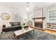 Stylish living room featuring hardwood floors, fireplace, and a large window at 428 N Humboldt St, Denver, CO 80218