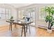 Bright office with hardwood floors, shuttered windows, modern desk, and a door leading to the backyard at 428 N Humboldt St, Denver, CO 80218