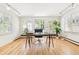 Bright office with hardwood floors, shuttered windows, modern desk, and a door leading to the backyard at 428 N Humboldt St, Denver, CO 80218