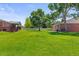 Well-manicured backyard with lush green grass, offering ample space at 9236 Vrain Ct, Westminster, CO 80031