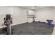 Finished basement with exercise area including equipment and white cabinets at 9236 Vrain Ct, Westminster, CO 80031