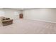 Spacious finished basement with neutral carpet and a cozy seating area at 9236 Vrain Ct, Westminster, CO 80031