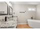 Modern bathroom with a soaking tub, double vanity, and granite countertops at 9236 Vrain Ct, Westminster, CO 80031