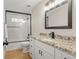 Modern bathroom featuring a marble countertop, sleek black fixtures, and a glass shower at 9236 Vrain Ct, Westminster, CO 80031