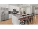 Contemporary kitchen with granite countertops, stainless appliances, and bar stool seating at 9236 Vrain Ct, Westminster, CO 80031