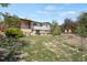 Expansive backyard boasts a wooden deck, a stone retaining wall, and a garden plot at 330 Johnson Dr, Castle Rock, CO 80104