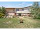 Grassy backyard with a patio, fire pit, wood deck, and beautiful, mature trees at 330 Johnson Dr, Castle Rock, CO 80104
