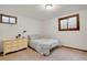 Bedroom with a small bed, beige dresser, and two windows at 330 Johnson Dr, Castle Rock, CO 80104