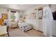 Bright bedroom with floral accents, a vanity, and natural light from dual windows at 330 Johnson Dr, Castle Rock, CO 80104