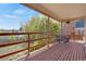 Covered deck with outdoor seating overlooking the landscaped yard and lush greenery at 330 Johnson Dr, Castle Rock, CO 80104