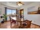 Bright dining room featuring wood table and chairs, decorative lighting, and a bright window overlooking the landscape at 330 Johnson Dr, Castle Rock, CO 80104