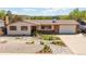 Charming ranch-style home with appealing xeriscaping and lush greenery on a sunny day at 330 Johnson Dr, Castle Rock, CO 80104