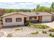 A charming single-story home with red shutters, complemented by natural desert landscaping at 330 Johnson Dr, Castle Rock, CO 80104