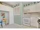Well-lit kitchen with white cabinets, appliances, and decorative blue patterned flooring at 330 Johnson Dr, Castle Rock, CO 80104