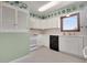 Bright kitchen with white cabinets, black appliances, and decorative plate accents at 330 Johnson Dr, Castle Rock, CO 80104