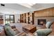 Living room with a brick fireplace, built-in shelves, and a sliding glass door to the backyard at 330 Johnson Dr, Castle Rock, CO 80104