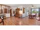 Open-concept space featuring hardwood floors, a decorative wood separator, a dining area, and two electric pianos at 330 Johnson Dr, Castle Rock, CO 80104
