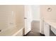 Bathroom offers a bath tub with shower and open door at 4105 N Dunkirk Ct, Denver, CO 80249